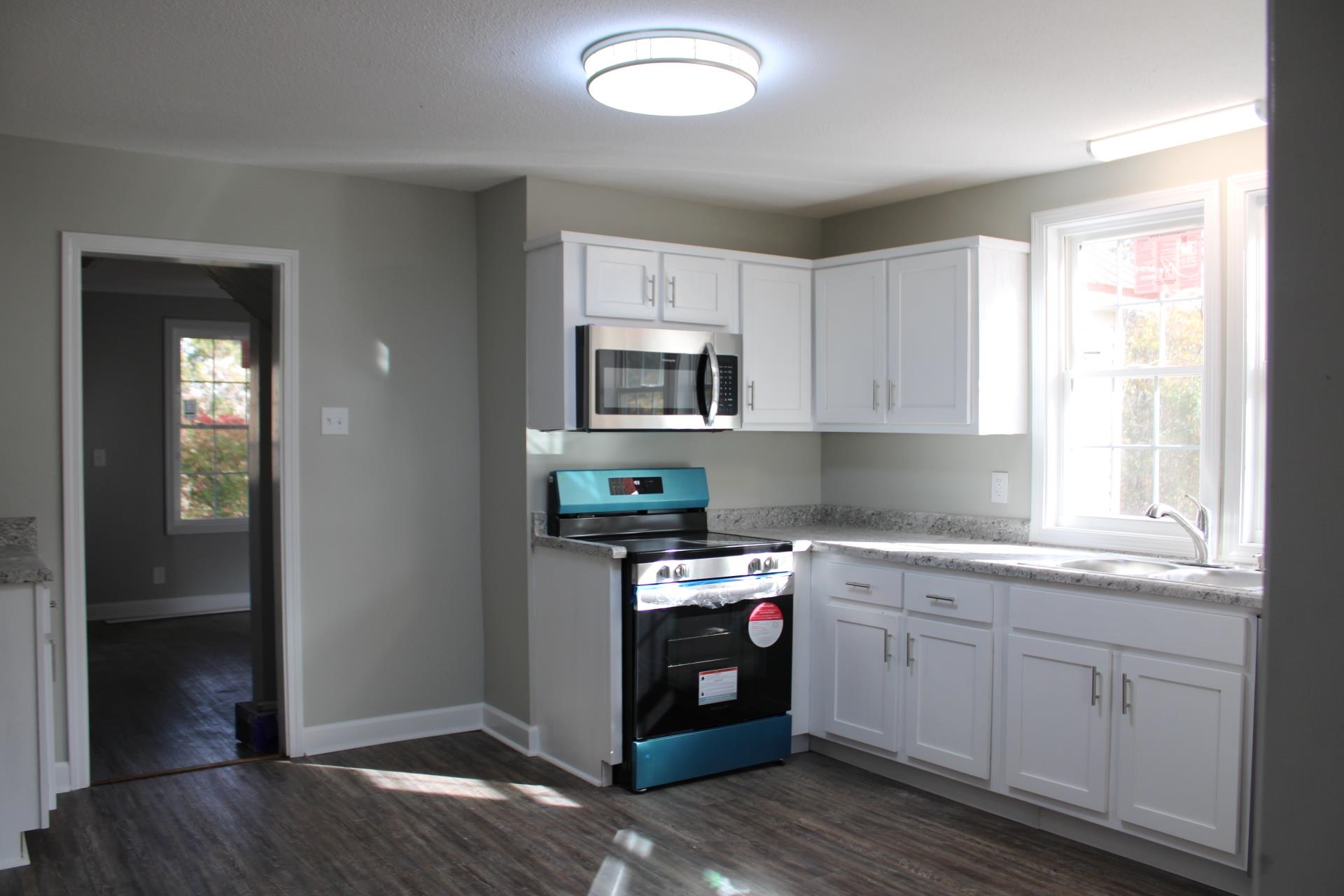 75 Curve Nankipoo Road Ripley, TN 38063 - Photo 6 of 22 a kitchen with granite countertop cabinets stainless steel appliances a sink and a window
