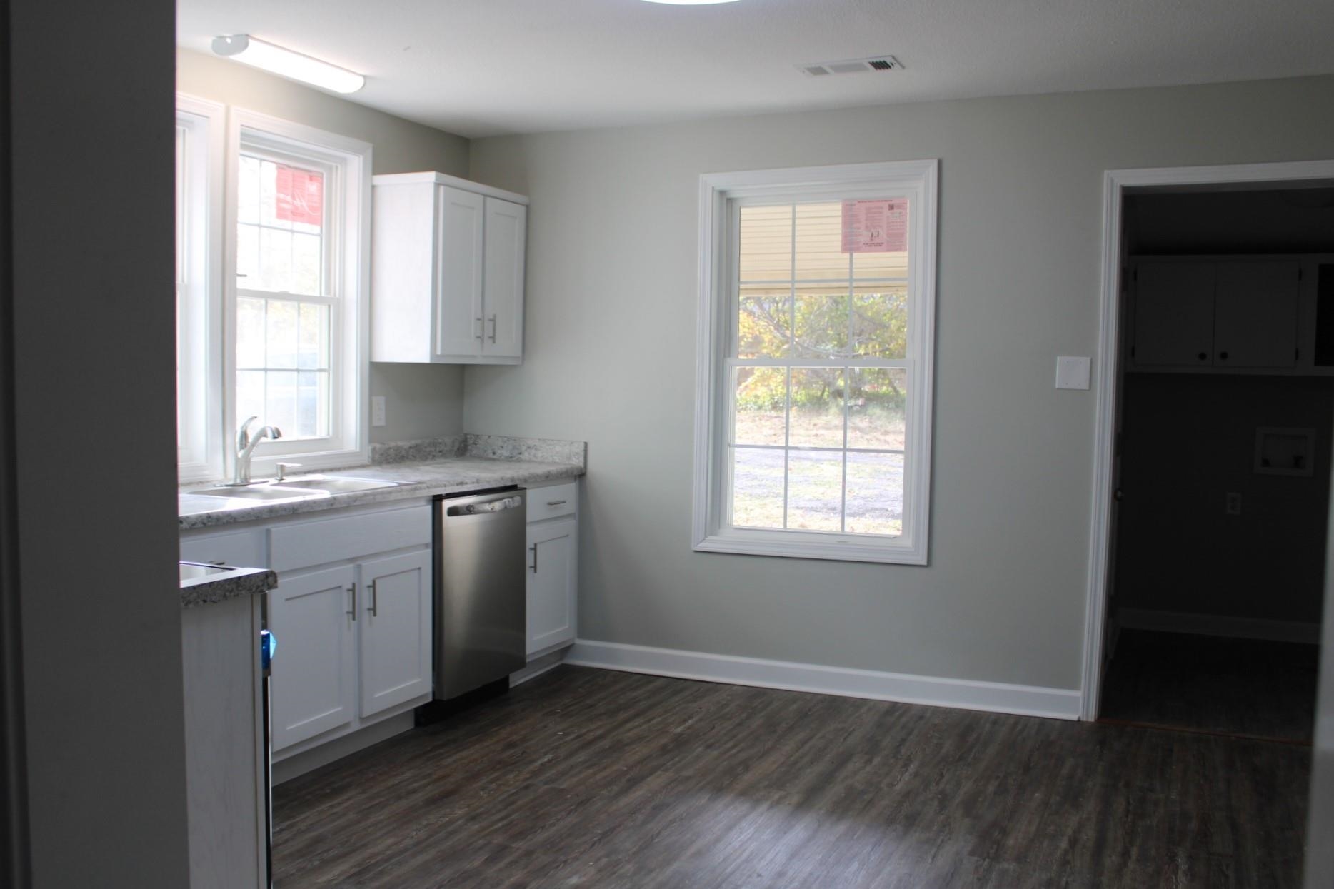 75 Curve Nankipoo Road Ripley, TN 38063 - Photo 7 of 22 a kitchen with granite countertop white cabinets and wooden floor