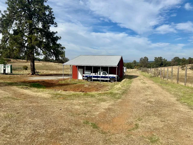a front view of house with yard and lake view
