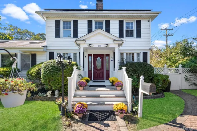 a front view of house with outdoor seating and yard