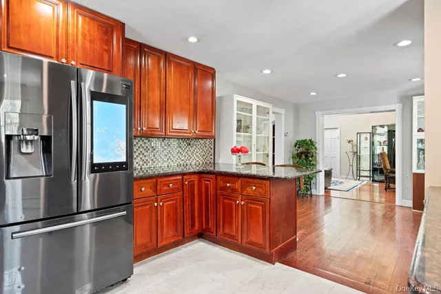 a kitchen with stainless steel appliances granite countertop a refrigerator and a sink