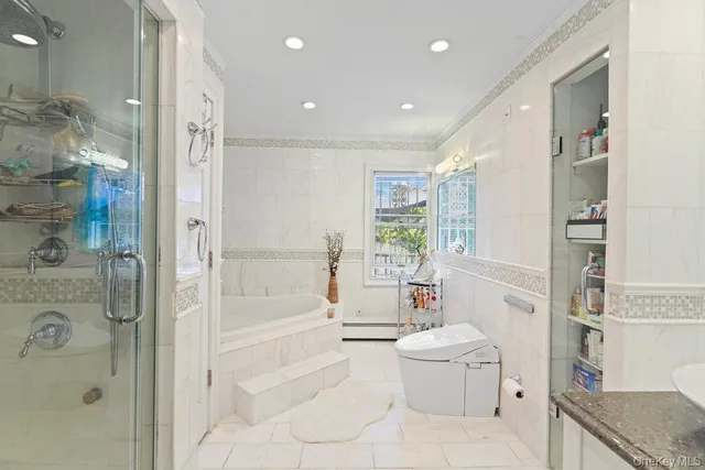 a bathroom with a granite countertop sink a toilet a tub and shower