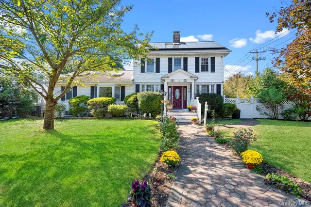 a front view of a house with a garden