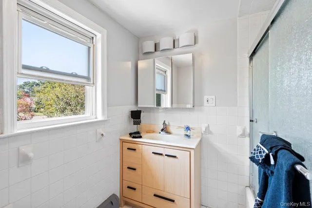 a bathroom with a sink vanity and a mirror
