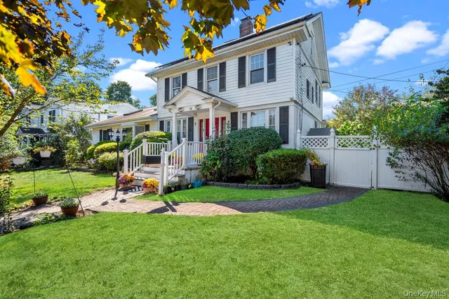 a view of a house with a yard and sitting area