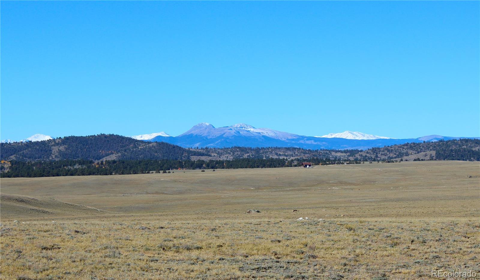 893 Rocky Mountain Road Hartsel, CO 80449 - Photo 3 of 31 a view of an lake with a mountain in the background