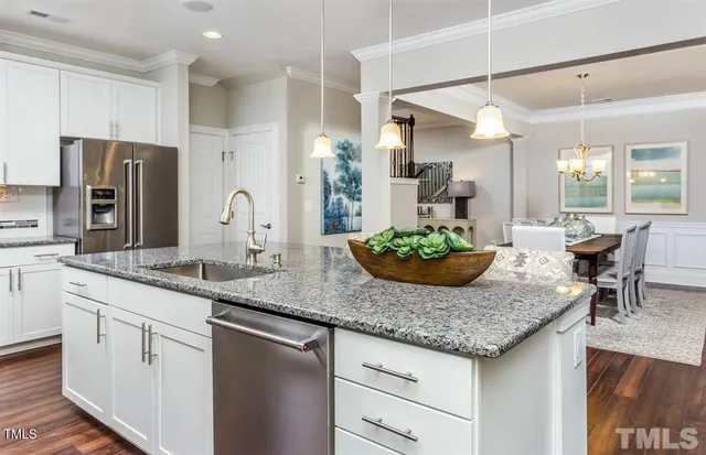 a kitchen with granite countertop kitchen island a counter space and stainless steel appliances