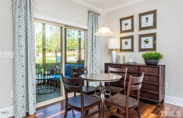 a view of a dining room with furniture window and wooden floor
