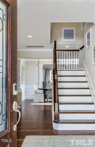 a view of entryway livingroom and hall with wooden floor