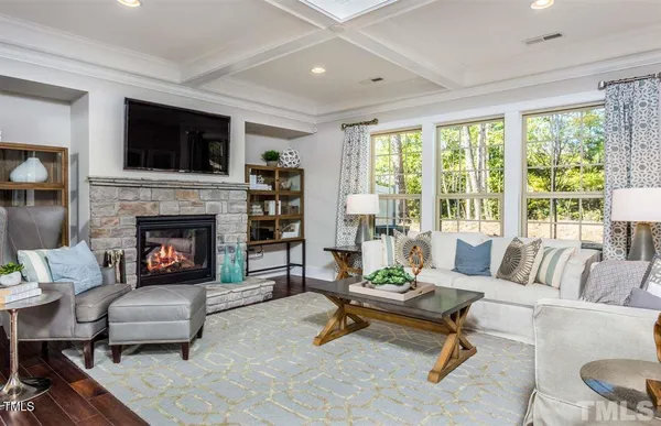 a living room with furniture fireplace and a flat screen tv