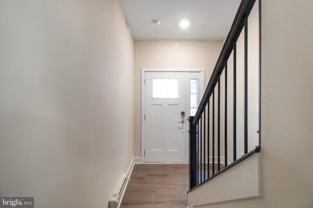 a view of entryway and hall with wooden floor