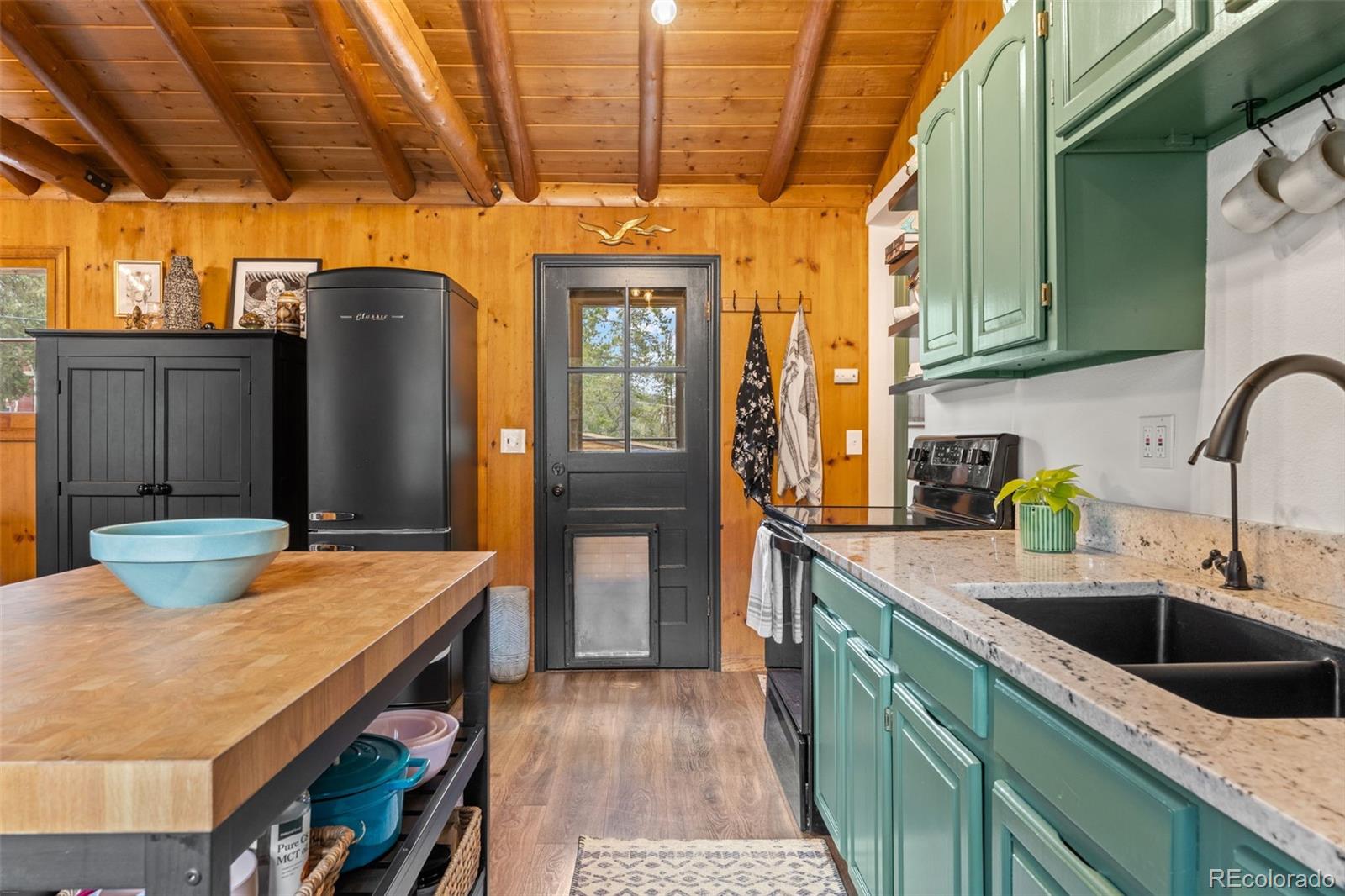 12159 Circle Drive Conifer, CO 80433 - Photo 22 of 49 a kitchen with stainless steel appliances wooden floor a sink and a refrigerator