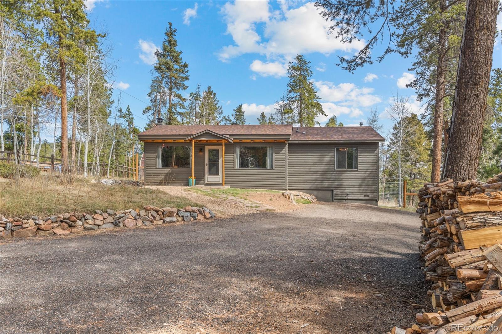 12159 Circle Drive Conifer, CO 80433 - Photo 45 of 49 a front view of a house with a garden
