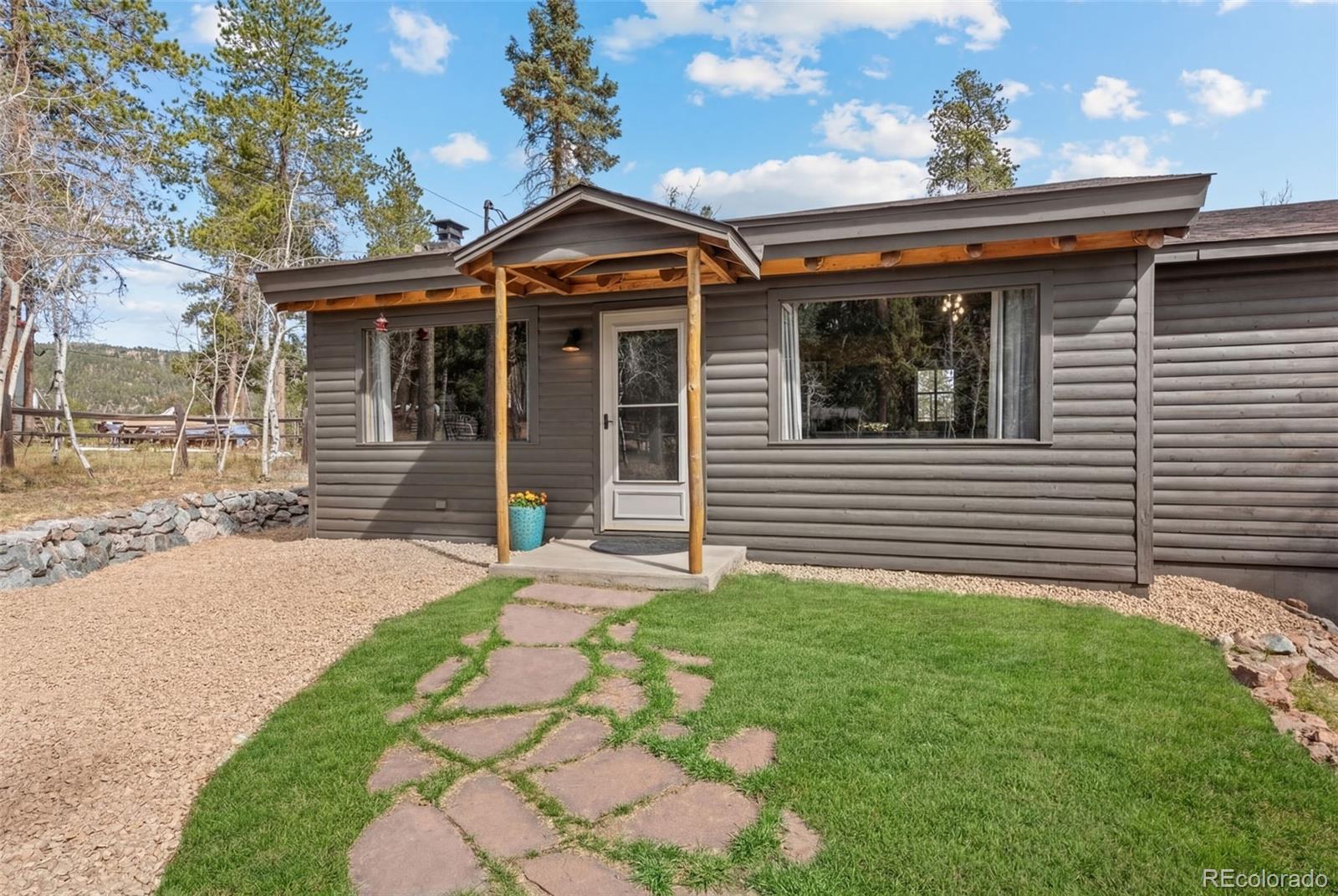 12159 Circle Drive Conifer, CO 80433 - Photo 47 of 49 a front view of a house with a garden and plants