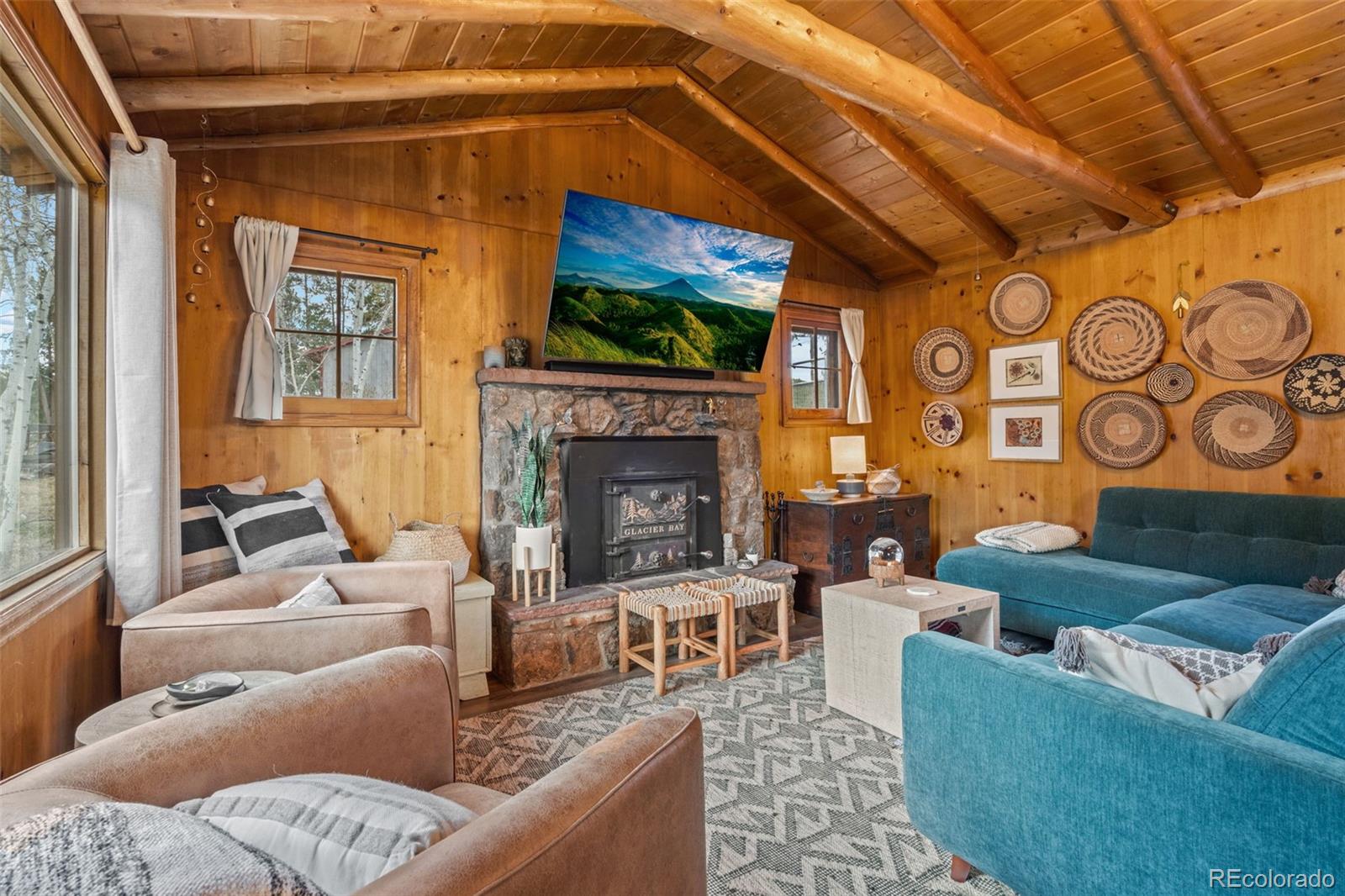 12159 Circle Drive Conifer, CO 80433 - Photo 7 of 49 a living room with furniture and a fireplace