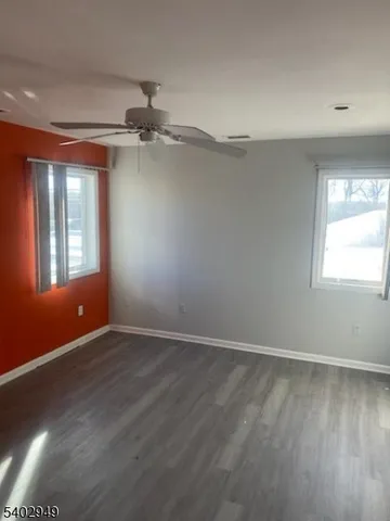 an empty room with wooden floor and closet