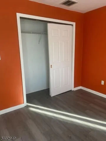 a view of an empty room with closet