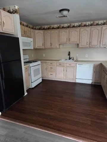 a kitchen with a cabinets and wooden floor