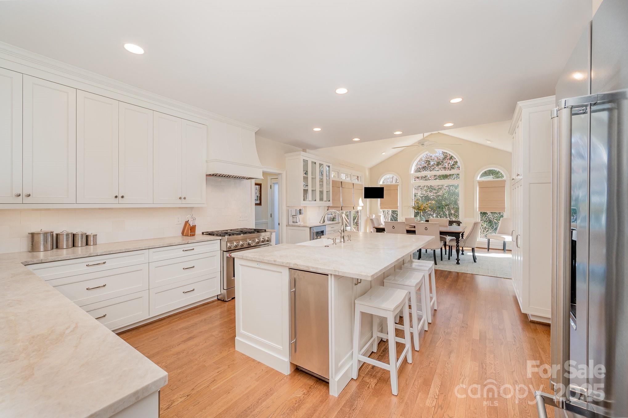 1531 Windy Ridge Road Charlotte, NC 28270 - Photo 5 of 44 a large kitchen with kitchen island white cabinets and stainless steel appliances