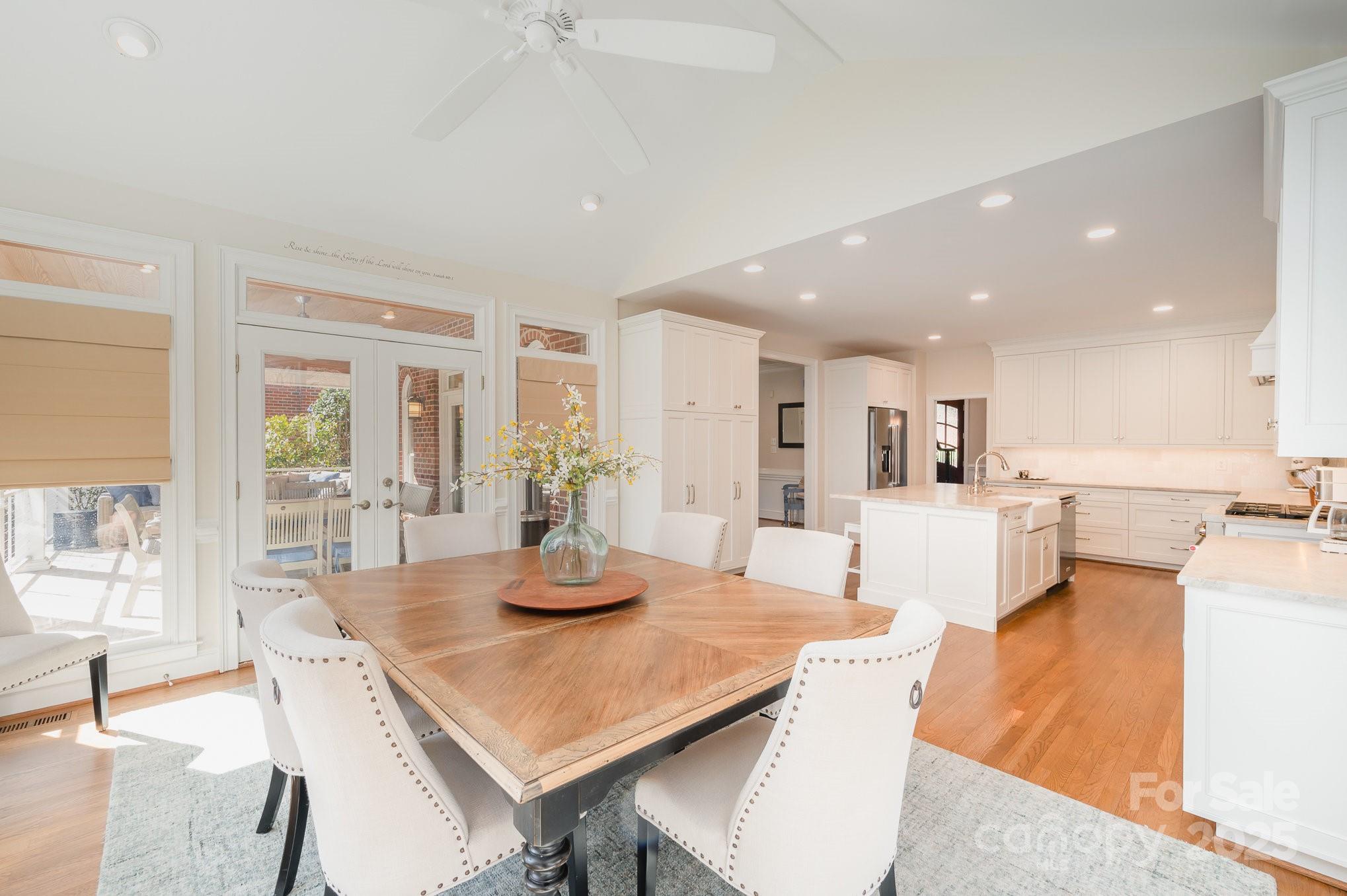 1531 Windy Ridge Road Charlotte, NC 28270 - Photo 6 of 44 a dining room with furniture a wooden floor and a kitchen view