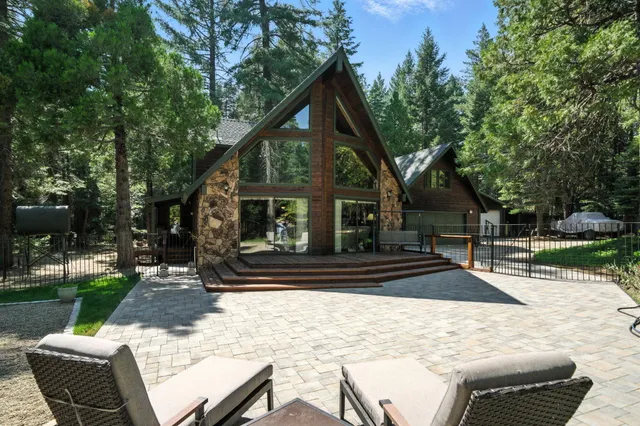 a view of a house with backyard and sitting area