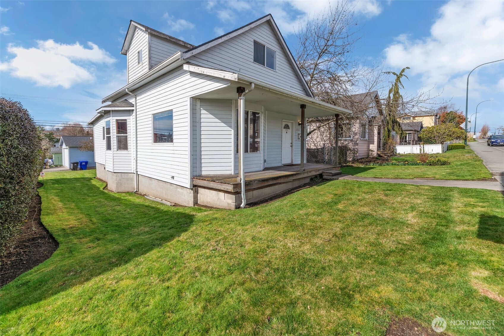 1332 East Marine View Drive Everett, WA 98201 - Photo 23 of 26 a view of a white house that has a small yard and large trees