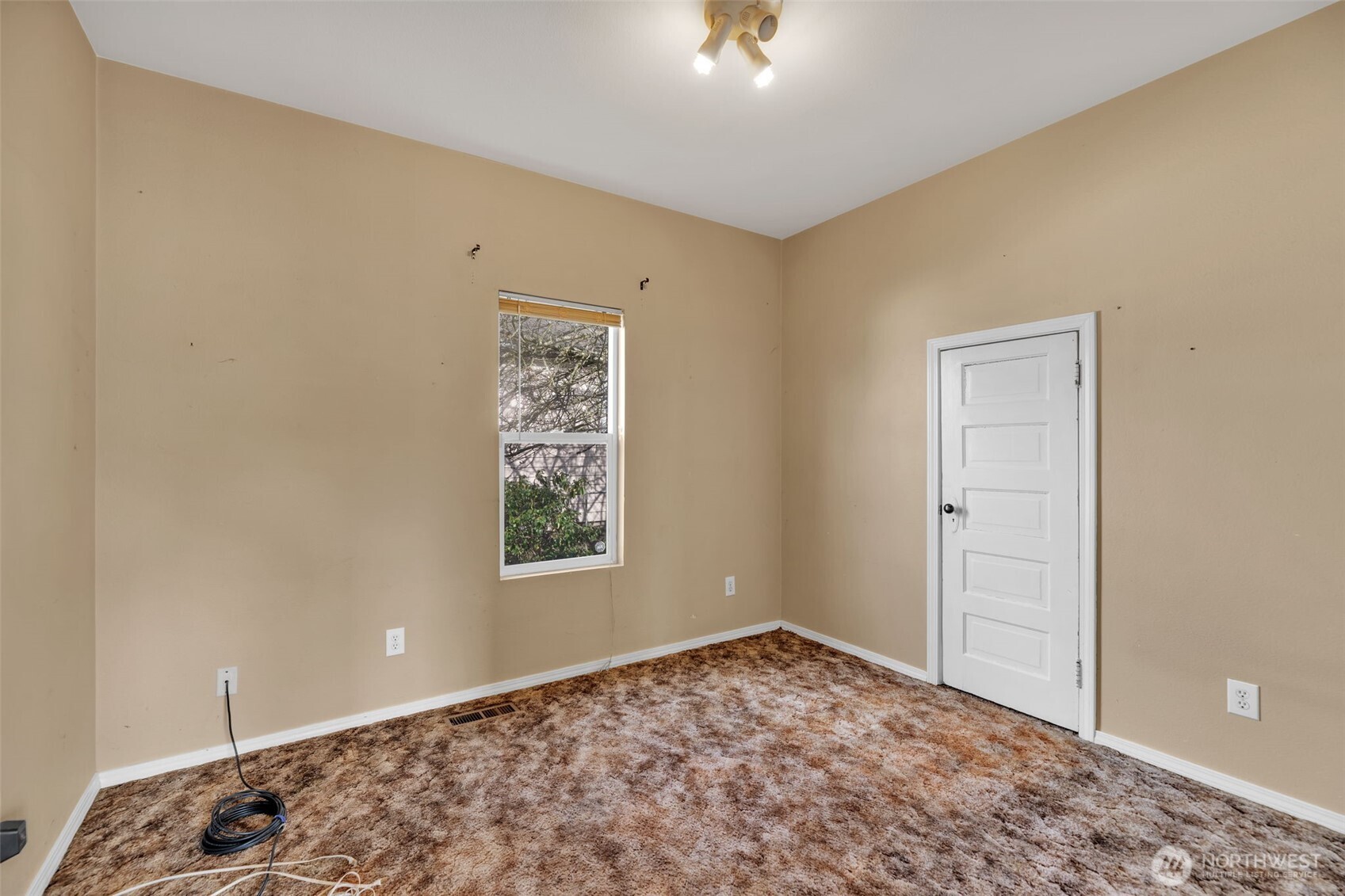 1332 East Marine View Drive Everett, WA 98201 - Photo 4 of 26 a view of a bedroom with a bed and a window