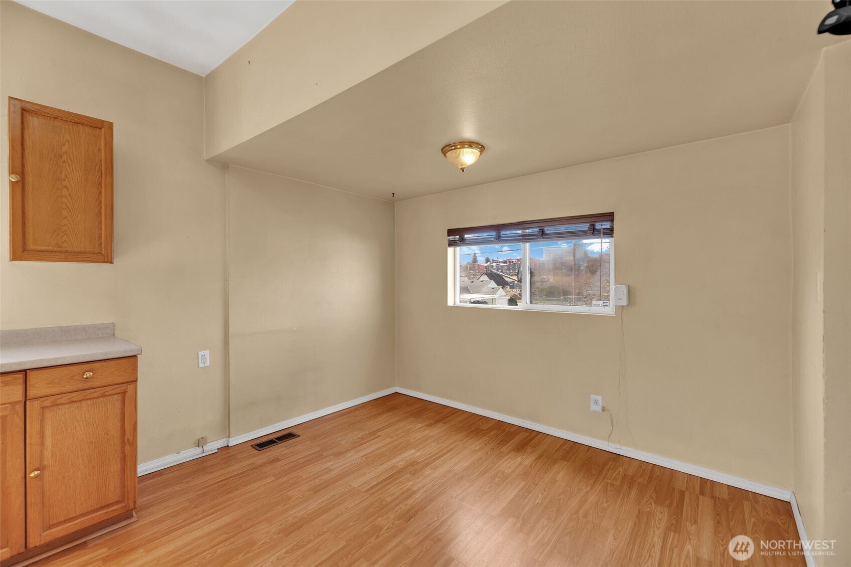1332 East Marine View Drive Everett, WA 98201 - Photo 10 of 26 an empty room with wooden floor and windows
