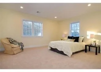 a spacious bedroom with a bed and window