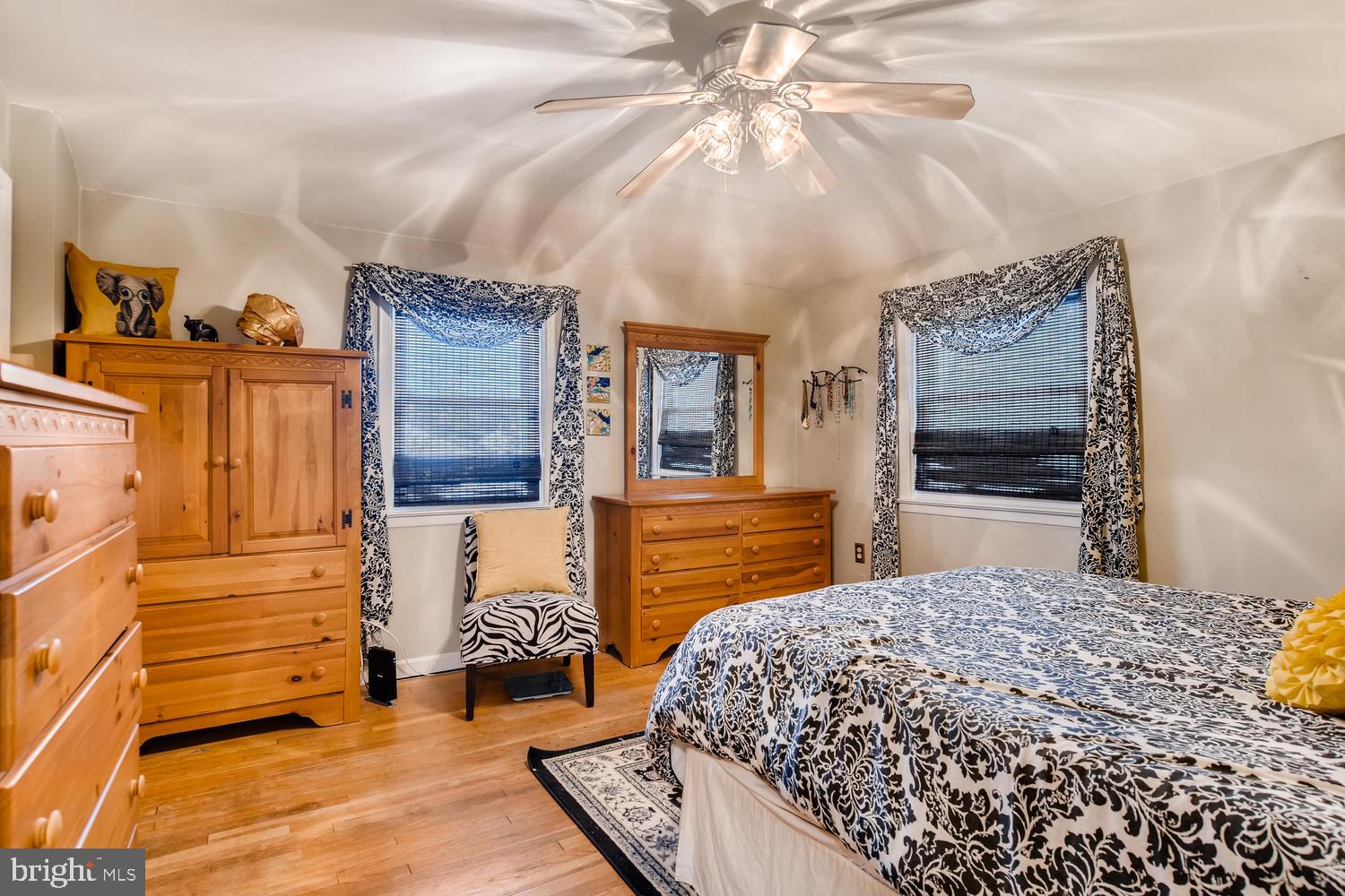 6803 Barnett Road Baltimore, MD 21239 - Photo 14 of 28 MAIN BEDROOM WITH HARDWOOD FLOORS AND CEILING FAN