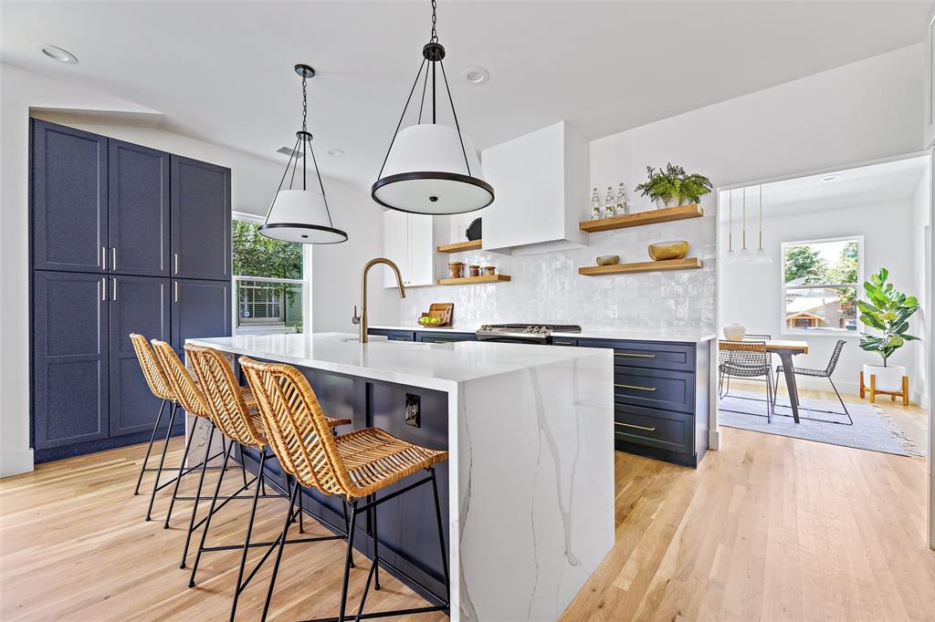 8903 Redondo Drive Dallas, TX 75218 - Photo 1 of 1 a kitchen with a table chairs and white cabinets