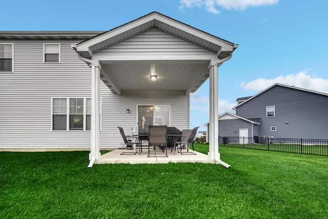 a front view of house with a garden and patio