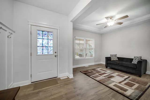 a kitchen with stainless steel appliances a dining table chairs stove refrigerator and cabinets