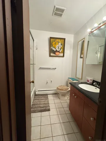 a bathroom with a sink a toilet and mirror