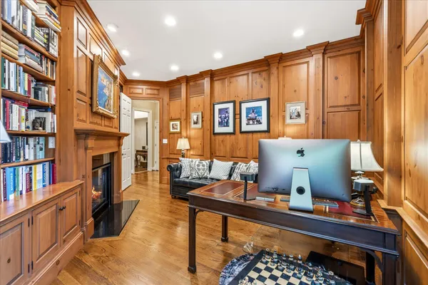 a living room with furniture fireplace and book shelf
