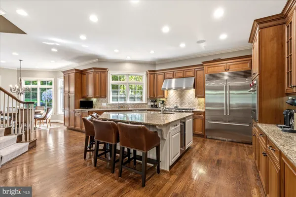 a kitchen with stainless steel appliances granite countertop a stove and refrigerator