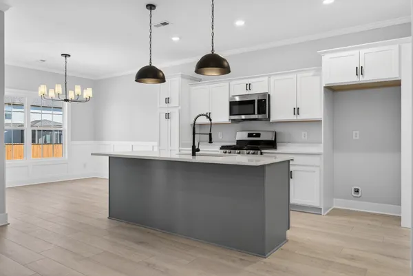 a kitchen with kitchen island a sink stainless steel appliances and cabinets