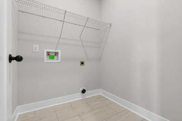 an empty room with a window and a ceiling fan