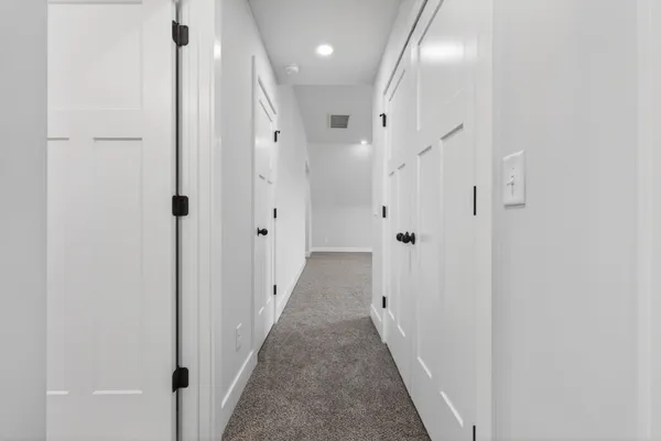 an empty room with windows and ceiling fan