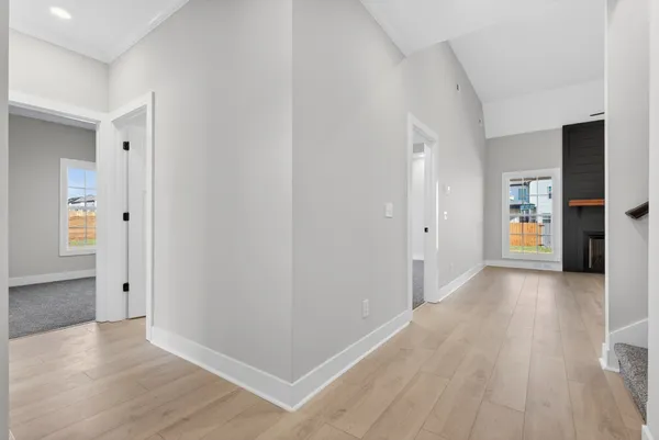 a view of a hallway with wooden floor