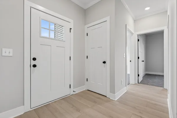 a view of a hallway with wooden floor and staircase
