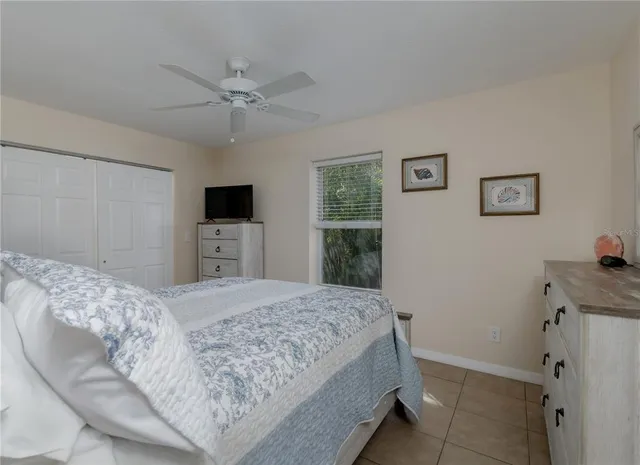 a bedroom with a large bed and a flat screen tv