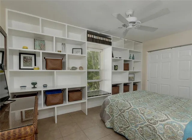 a large bedroom with a bed and a chandelier