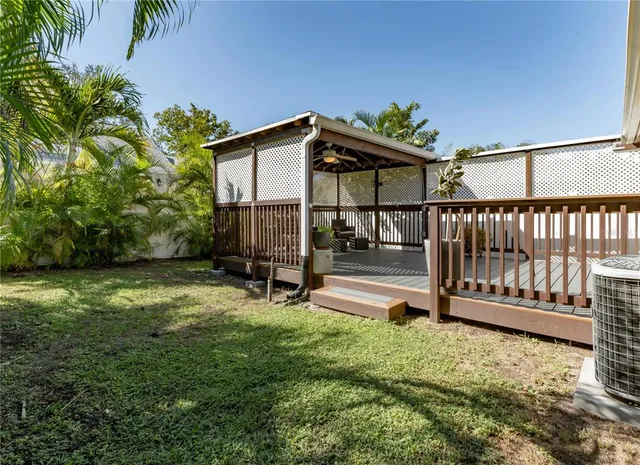 a view of a house with backyard and sitting area
