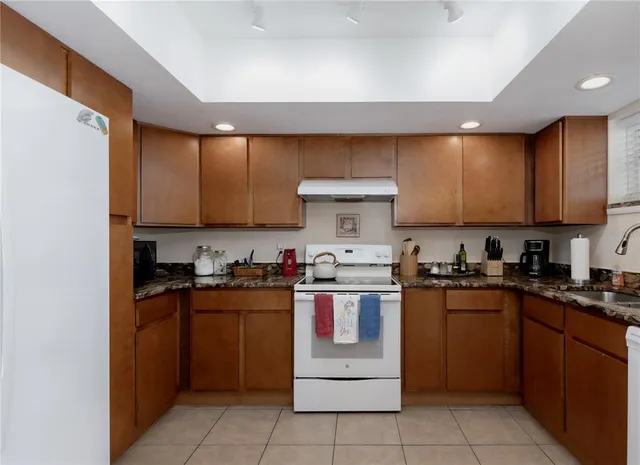 a kitchen with a stove top oven sink and cabinets