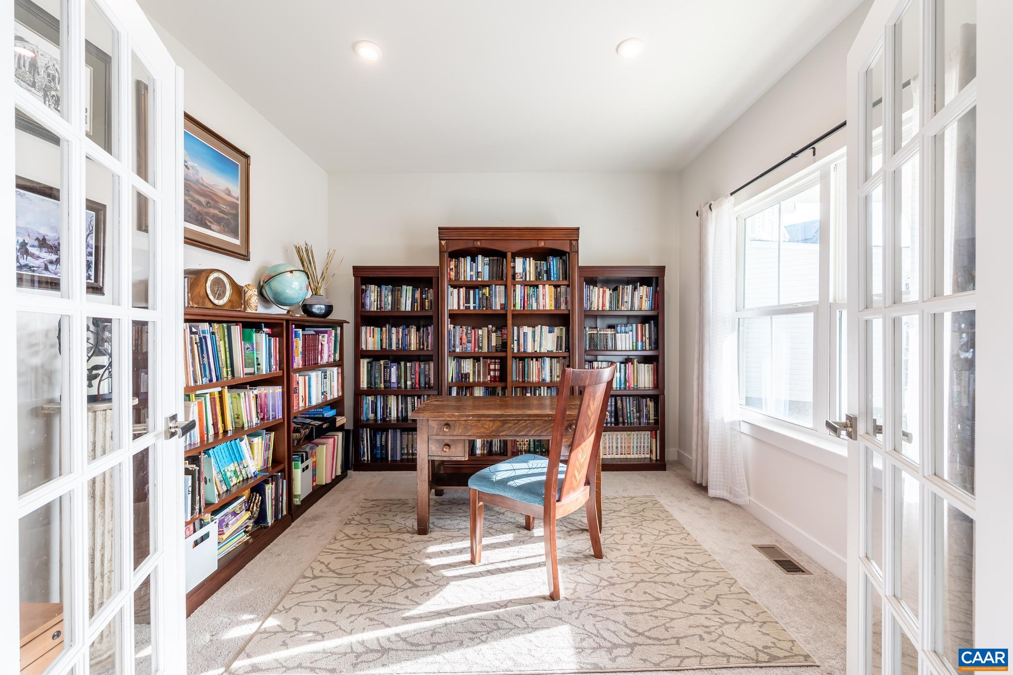 4585 Sunset Drive Charlottesville, VA 22911 - Photo 18 of 70 a view of a workspace with furniture and a bookshelf