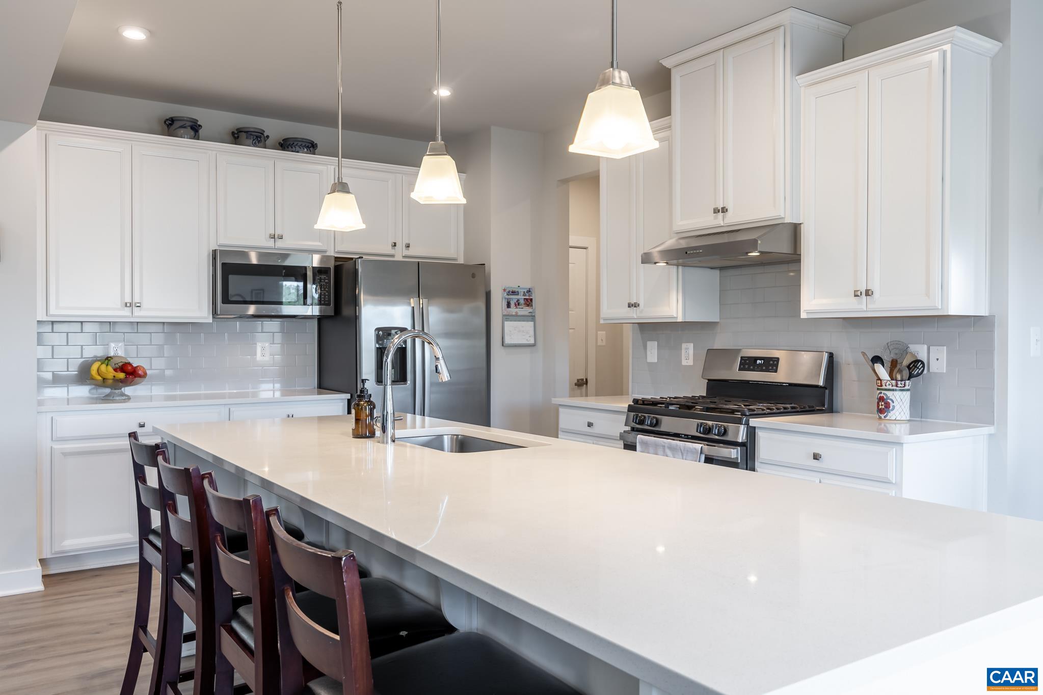 4585 Sunset Drive Charlottesville, VA 22911 - Photo 25 of 70 a kitchen with stainless steel appliances a stove a sink a dining table and chairs