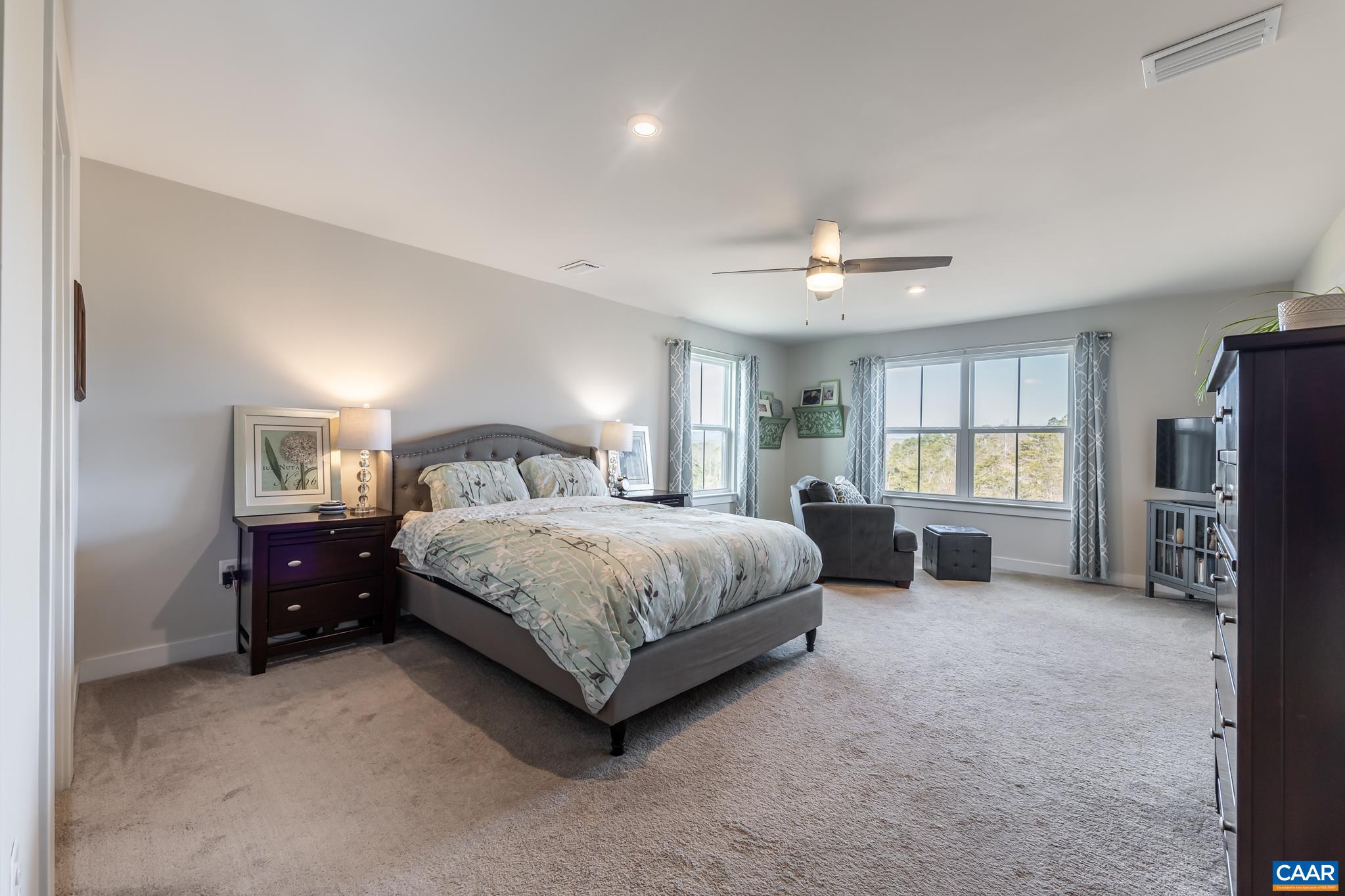 4585 Sunset Drive Charlottesville, VA 22911 - Photo 37 of 70 a spacious bedroom with a bed a dresser and a chandelier