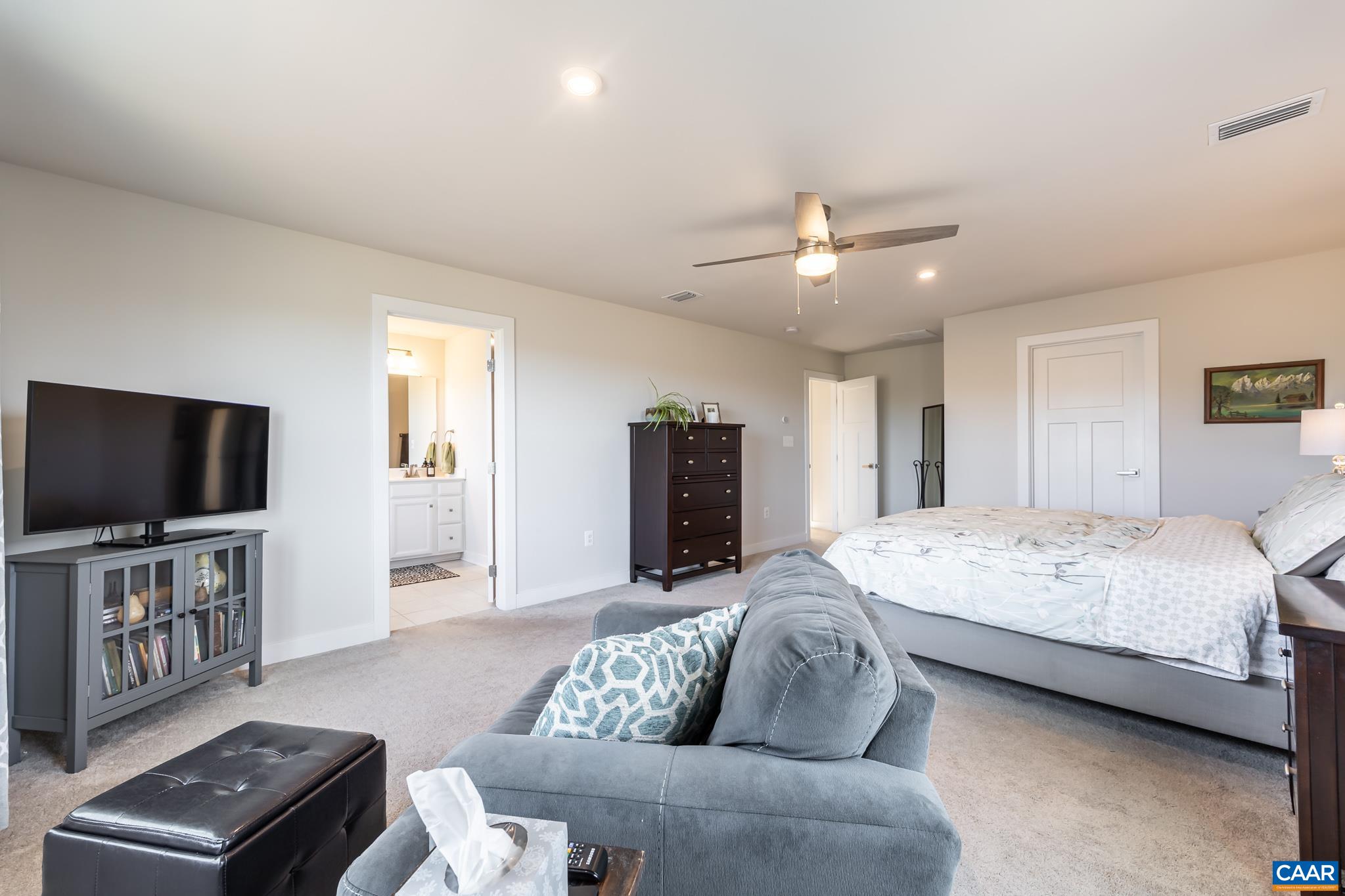 4585 Sunset Drive Charlottesville, VA 22911 - Photo 39 of 70 a spacious bedroom with a bed and a flat screen television
