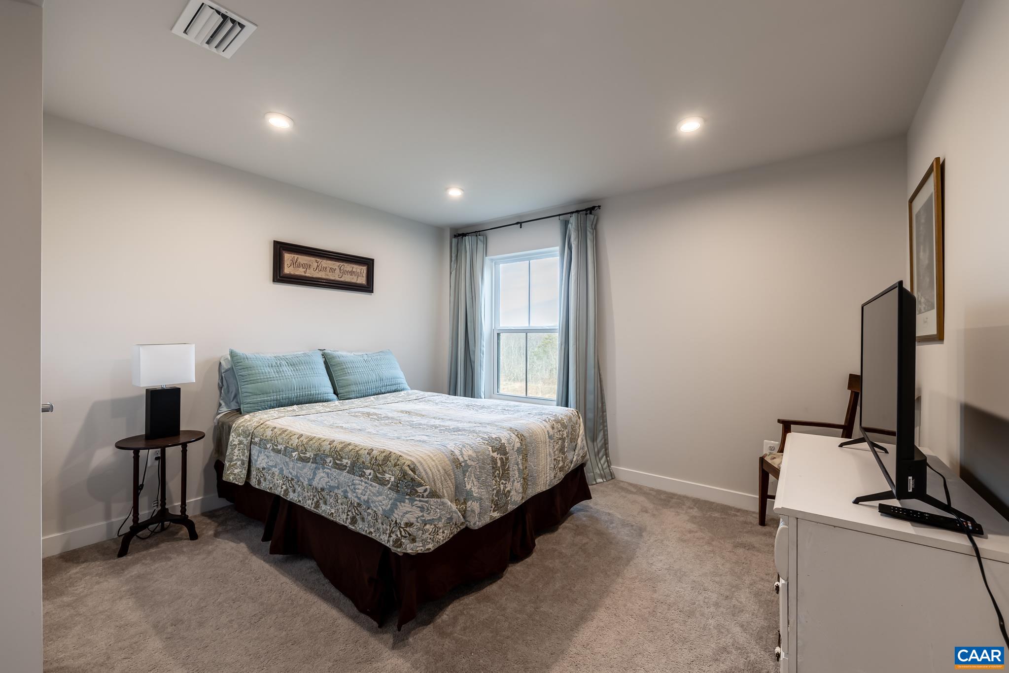 4585 Sunset Drive Charlottesville, VA 22911 - Photo 57 of 70 a spacious bedroom with a bed and a flat screen tv